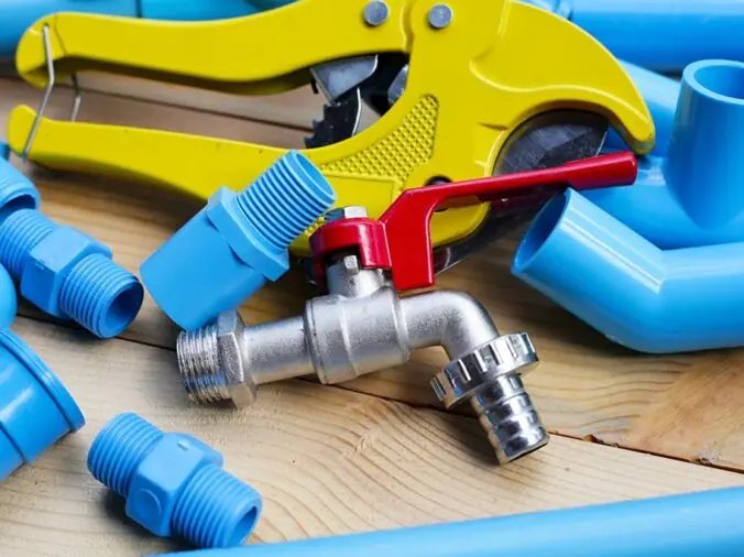 Blue PVC pipe fittings, stell valve and plumbing pipe cutting tool
