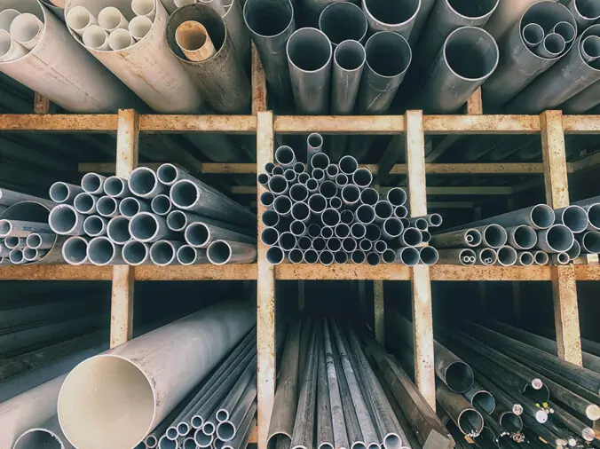 PVC pipes on shelves in a wholessale plumbing supply store warehouse