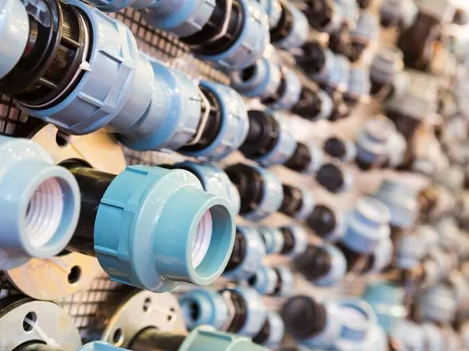 PVC union fittings on wall in plumbing supply warehouse