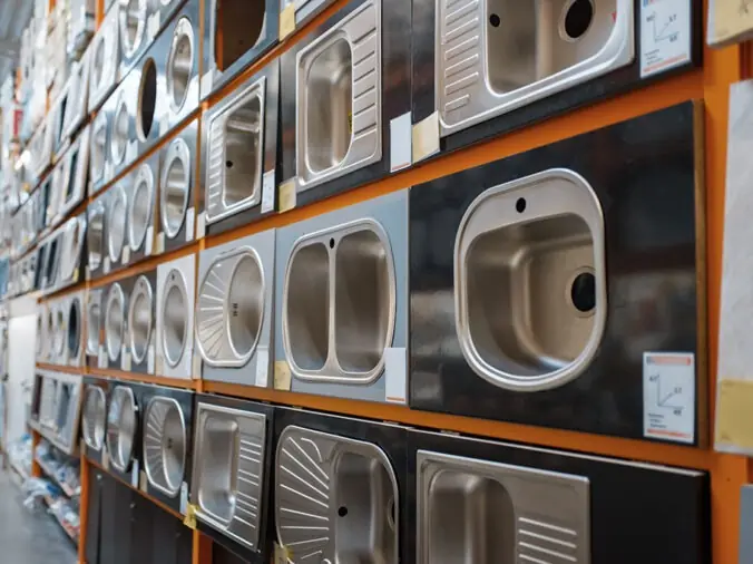 Wall of kitchen sinks in plumbing supply showroom
