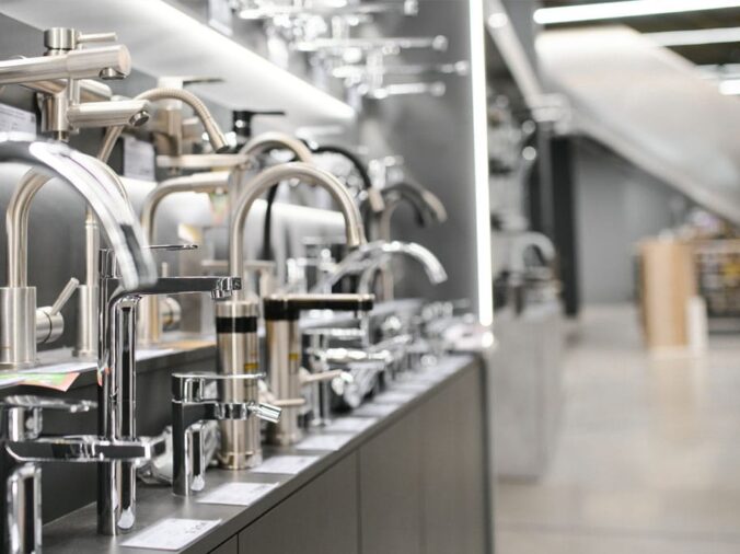 Kitchen sink faucets in a plumbing supply showroom